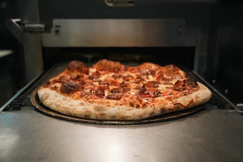 Pepperoni Feast pizza loaded with crispy pepperoni at Papa Ginos